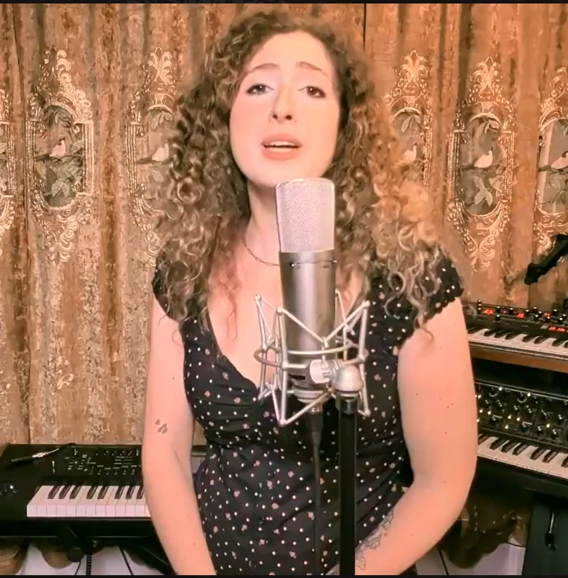 Rachel Silvers singing into a studio microphone